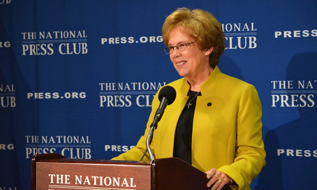 Sister Donna Markham, former president and CEO of CCUSA, makes an address at a podium at the National Press Club.